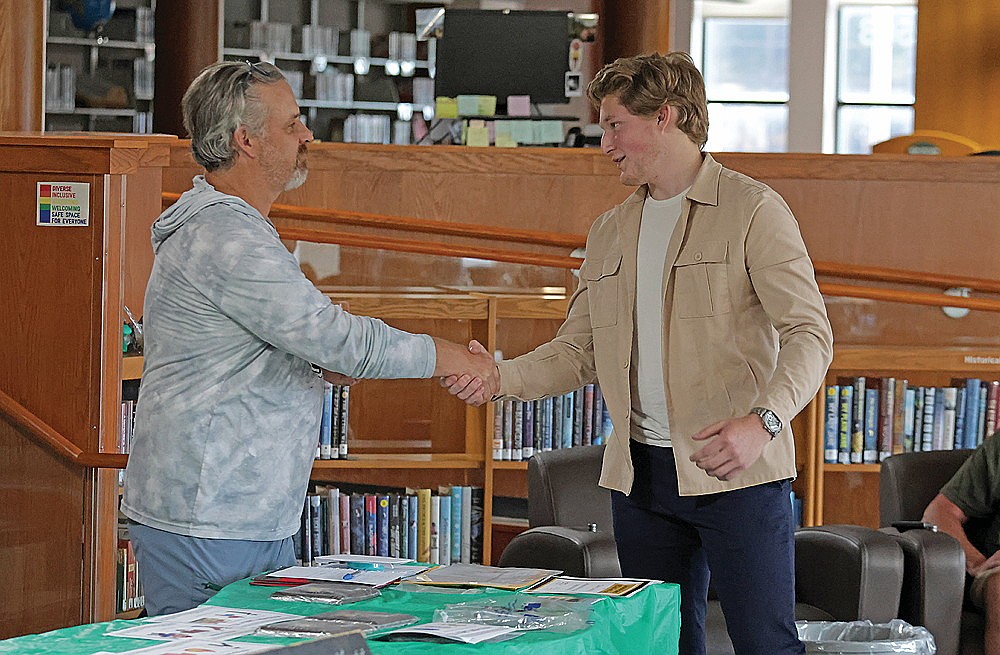 Rhinelander’s Payton McCue, right, receives the Rhinelander High School boys’ tennis team’s Hodag Citizen Award from assistant coach Wil Losch during the team’s year-end banquet in the RHS Library Monday, June 16. (Jeremy Mayo/River News)