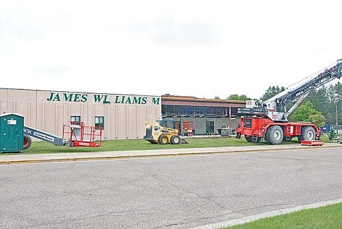 Demolition crews tear down the front concrete panel wall at James Williams Middle School last week. The entire office area was gutted as well. (Photo by Bob Mainhardt for the River News)