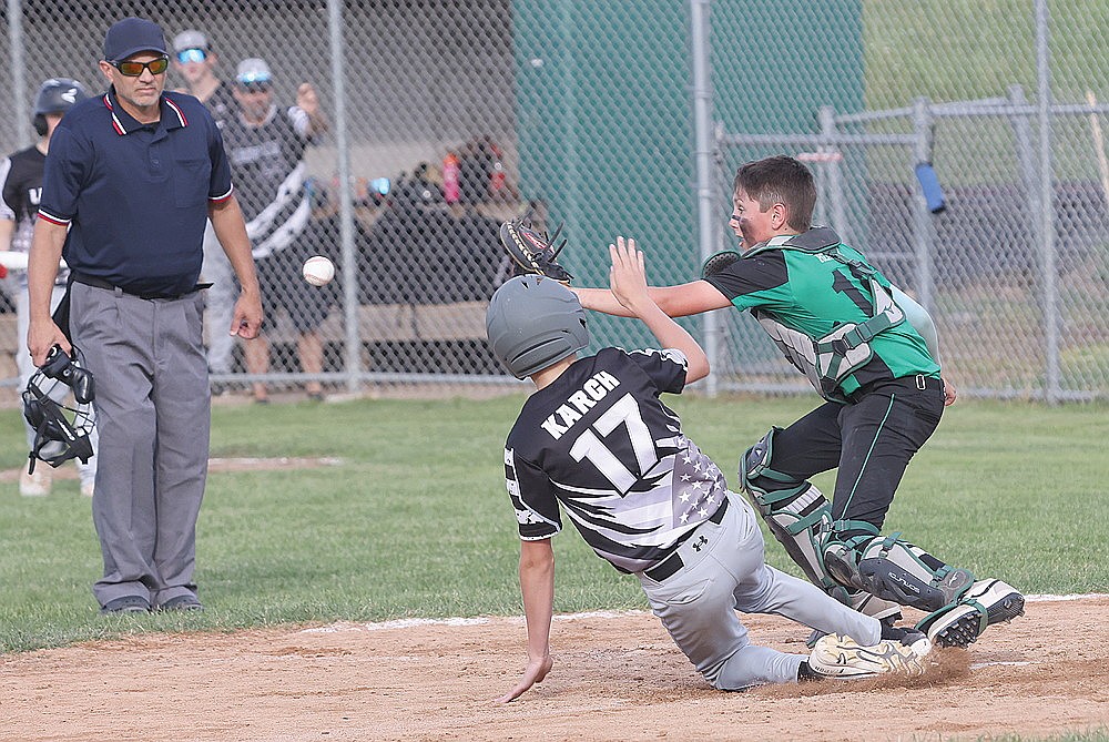 Rhinelander’s Mason Hauser attempts to tag out Lakeland’s Caleb Karch in a play at the plate during a Northwoods Babe Ruth Prep League game at Stafford Field Tuesday, June 24. (Bob Mainhardt for the River News)