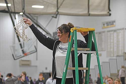 In this March 1, 2025 file photo, Melissa Ouimette cuts down the net following Lakeland’s 66-40 win over Mosinee in a WIAA Division 2 regional final game at Ted Voigt Court in Minocqua. Ouimette resigned at the end of the season, finishing her Lakeland tenure with a career record of 186-67. (Photo by Brett LaBore/Lakeland Times)