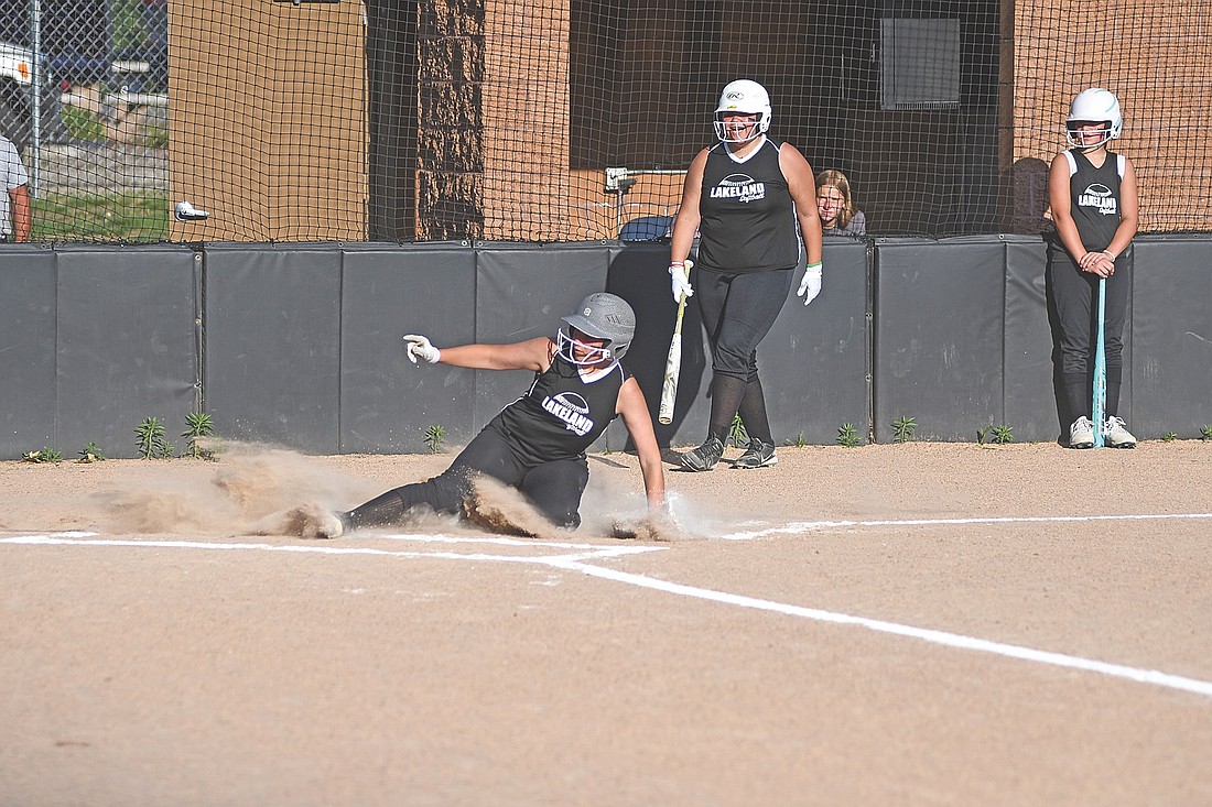 Kaitlyn Moore slides home safely for a run in the first inning against Rhinelander Tuesday, June 24 at Lenz Field in Minocqua. (Photo by Brett LaBore/Lakeland Times)