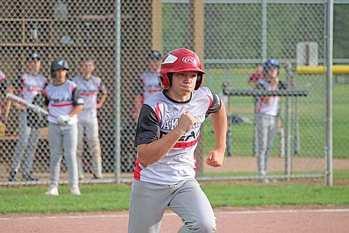 Sean Sass runs to first after hitting a grounder during a Babe Ruth league game against Rhinelander Monday night in Minocqua. (Photo by Trevor Greene/Lakeland Times)