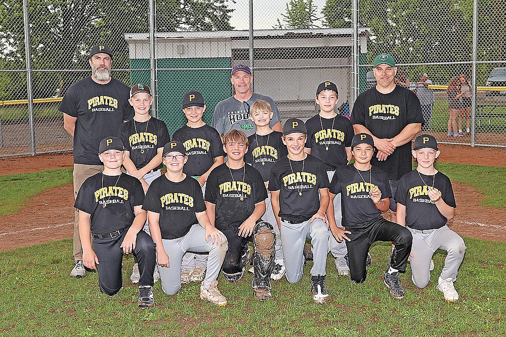 The Pirates pose with the championship rings following the Major league championship game against the Cubs. In the front row, from left to right are Esra Codere, Isaac Bauer, Griffin Rady, Eli Bauer, Raymond Mutter and Kolt Taylor. In the second row are Jeter Vander Galien, Easton Rady, Fletcher Gehrmann and Sawyer Sackett. In the back row are coaches Shawn Codere, Jeremy Vander Galien and Eric Rady.