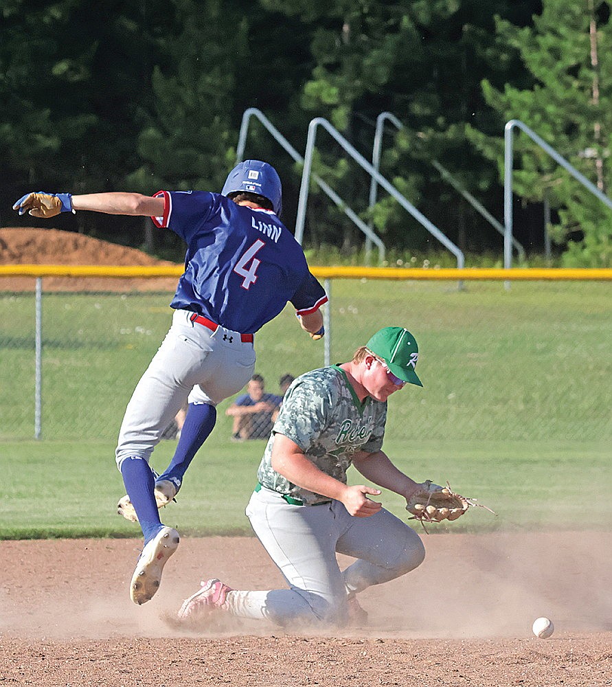 Rhinelander’s Tyler Chariton knocks down a throw to second as Northwoods’ Jason Linn returns to the base during the first inning of an American Legion baseball game in Eagle River Monday, July 7. Northwoods scored nine times in the first inning and defeated Rhinelander, 11-2. (Jeremy Mayo/River News)