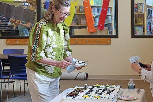 Peggy O’Connell enjoys the first piece of cake during a retirement party held for her at the Minocqua Public Library on Tuesday, July 1. (Photo by Kate Reichl/Lakeland Times)