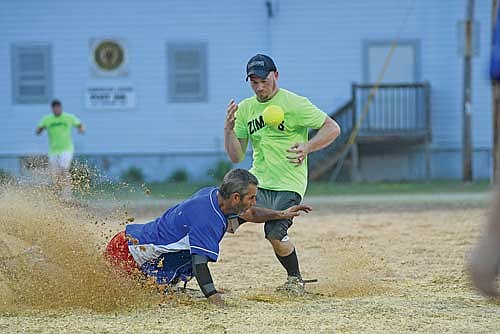 Don Moore, left, and Tommy Ziemba, Zimmy’s All-Stars, collide at second base in the sixth inning of a snowshoe baseball game Monday, July 14 at Snowshoe Park in Lake Tomahawk. (Photo by Brett LaBore/Lakeland Times)