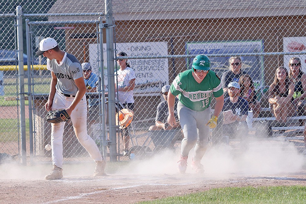 Rhinelander’s Tyler Chariton scores on a passed ball while Minocqua pitcher Ben Peterson covers the plate during the second inning of an American Legion baseball game in Minocqua Monday, July 14. The Rebels defeated the 89ers, 10-0. (Bob Mainhardt for the River News)