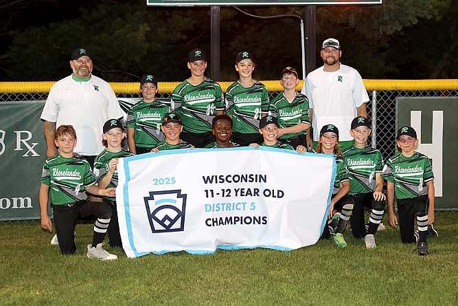 The Rhinelander Little League’s 12U All-Star poses with its championship banner following Tuesday’s game. In the front row, from left to right, are Blake Sundby, Kolt Taylor, Griffin Rady, Jaxon Eades, Rylan Pasanen, Cooper Clark, Jeter Vander Galien and Mason Paulson. In the back row are coach Kevin Eades, Will Sundby, Easton Sieker, Eli Bauer, Nick Schneider and manager Josh Clark.  (Photo by Bob Mainhardt/River News)