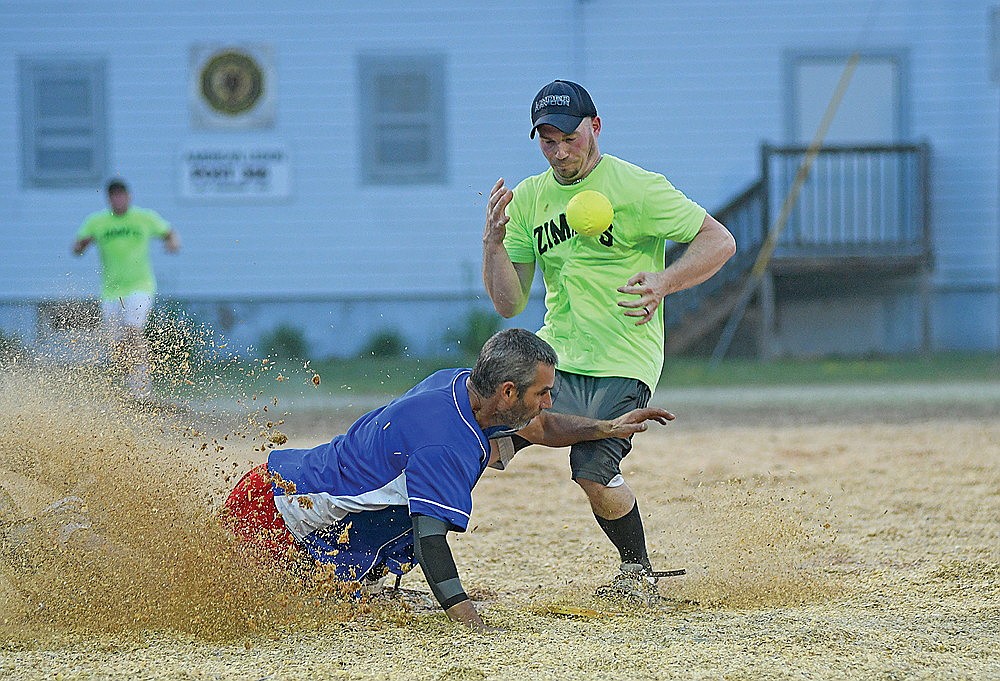 Don Moore, left, and Tommy Ziemba, Zimmy’s All-Stars, collide at second base in the sixth inning of a snowshoe baseball game Monday, July 14 at Snowshoe Park in Lake Tomahawk. (Brett LaBore/Lakeland Times)