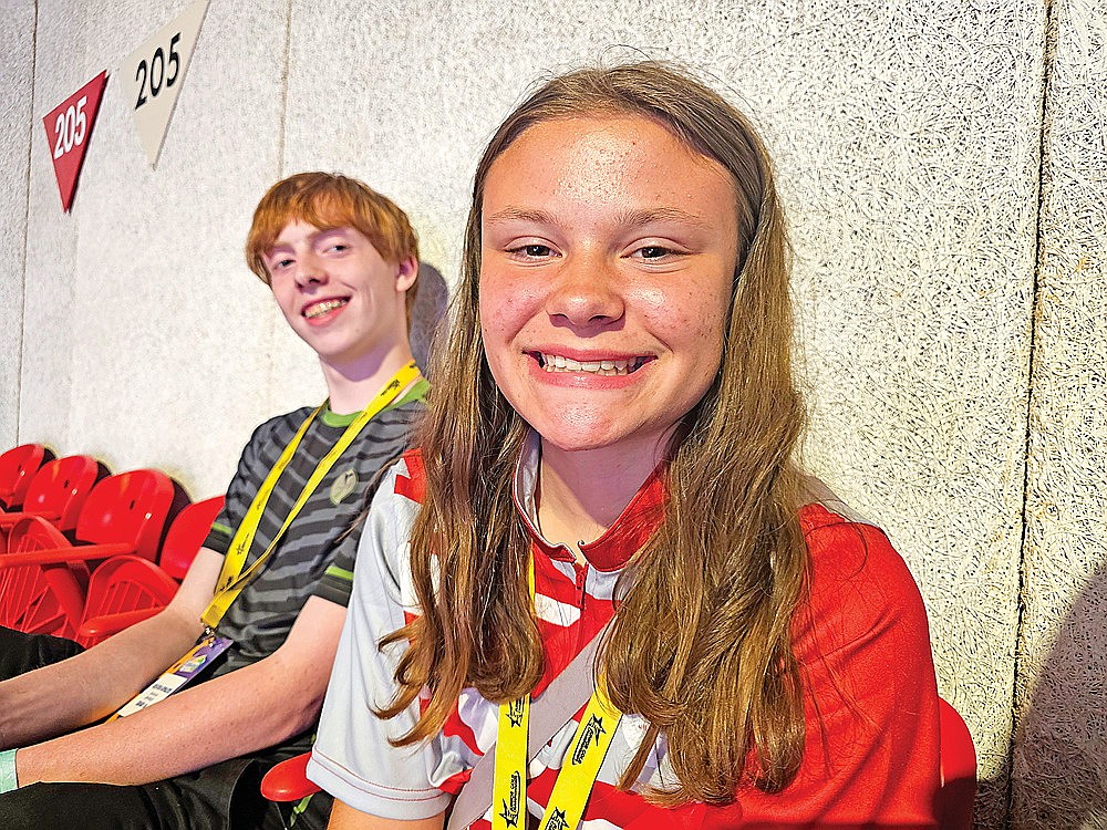 Rhinelander Bowling Club members Eli Miller, left, and Natalie Dellenbach, right watch from the stands during the Junior Gold National Youth Tournament opening ceremonies in Green Bay. The two competed in the U15 Divisions during Junior Gold tournament and walked with “Team Wisconsin” during the opening ceremonies. (Cory Dellenbach/Submitted)