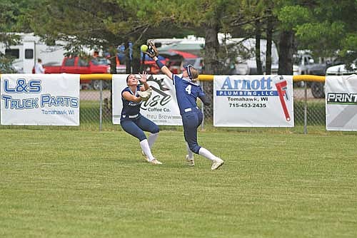 Ciara Christianson attempts to catch the ball with Ariah Peterson closing in against the Elite during the Rod Timm Memorial Girls’ Fast Pitch Tournament Saturday, July 19 at Sara Park in Tomahawk. (Photo by Brett LaBore/Lakeland Times)