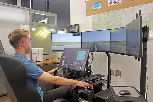 Aviation specialist Riley Zarm navigates a takeoff using Nicolet College’s new FAA-approved flight simulator. (Photo by Michael Strasburg/Lakeland Times)