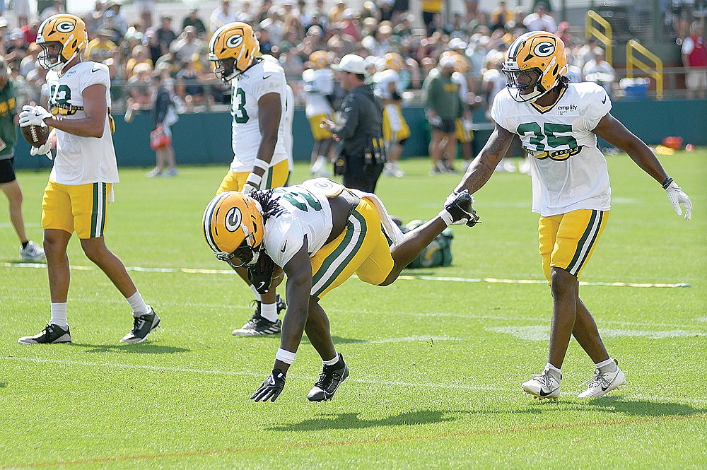 Running backs Israel Abanikanda, left, and Jalen White go through a drill.