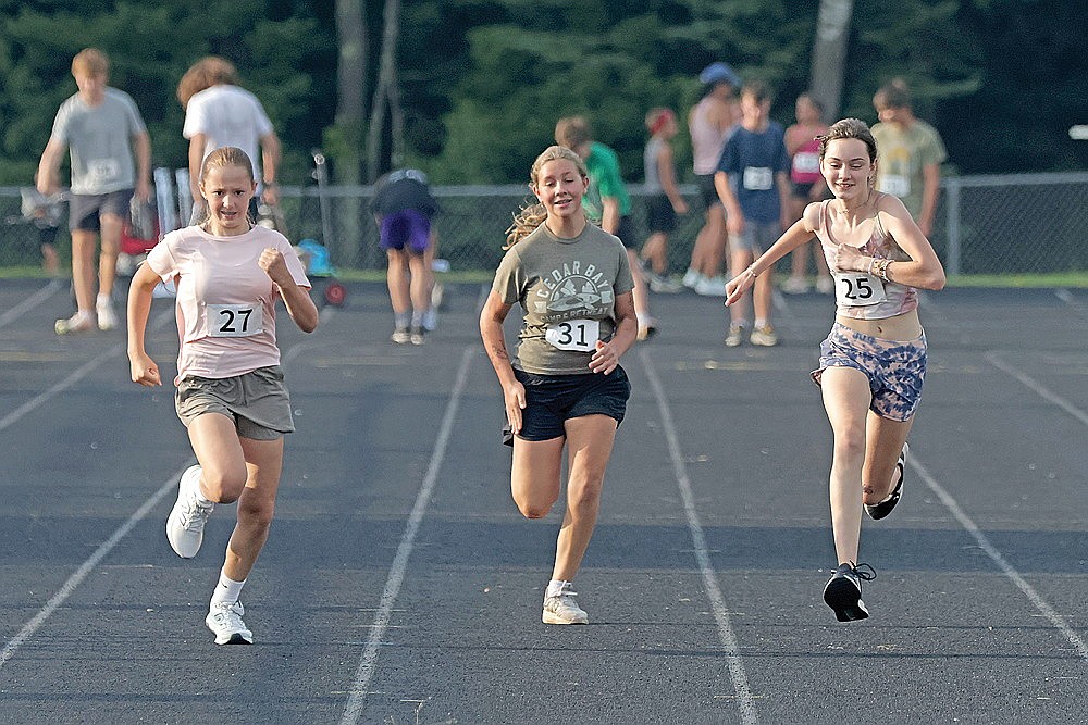 Naomi Borkehagen (27) of Rhinelander, Myra Holmquist (31) of Lake Tomahawk and Fjola Erickson (25) of Tomahawk compete in the 100-meter dash.