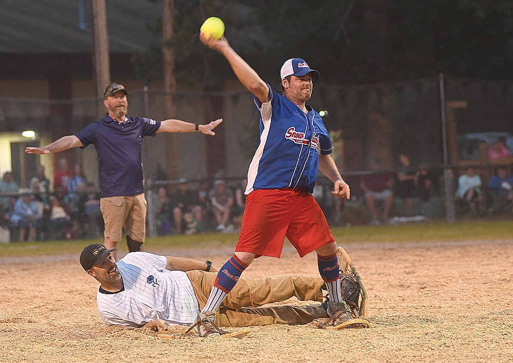 Marc Seils throws home with Wickman Construction’s Chad Johnson at second base and umpire Arne Lee signaling safe in the fifth inning Monday, Aug. 4 at Snowshoe Park in Lake Tomahawk. (Brett LaBore/Lakeland Times)