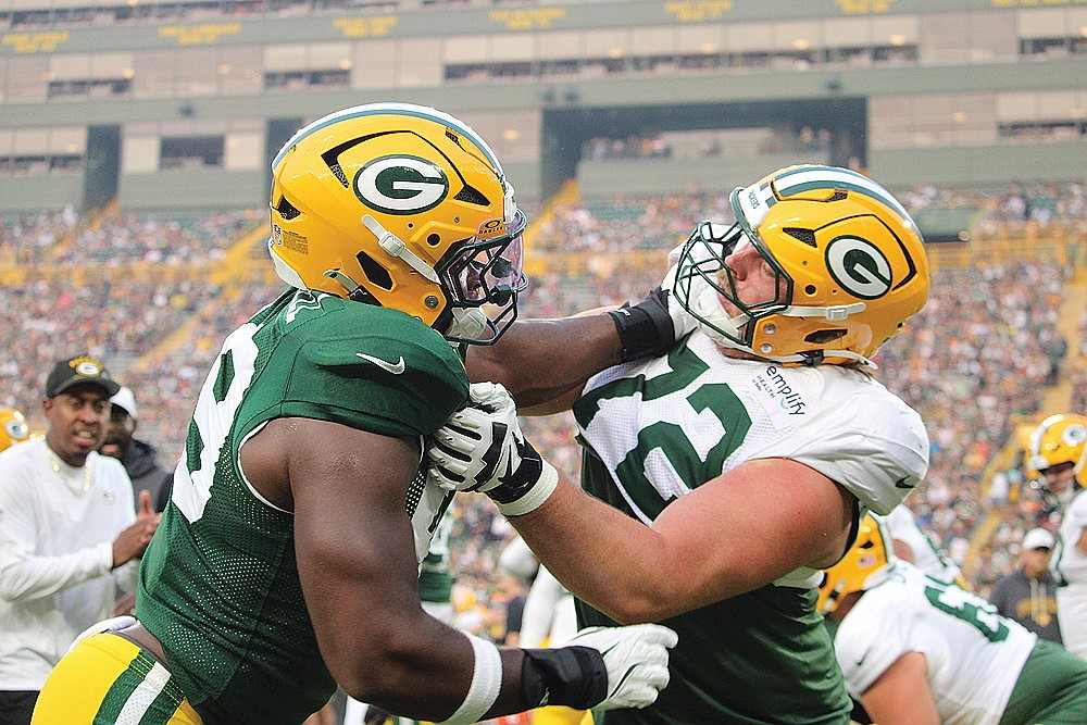 Defensive lineman Barryn Sorrell goes up against offensive tackle Brant Banks during a drill.
