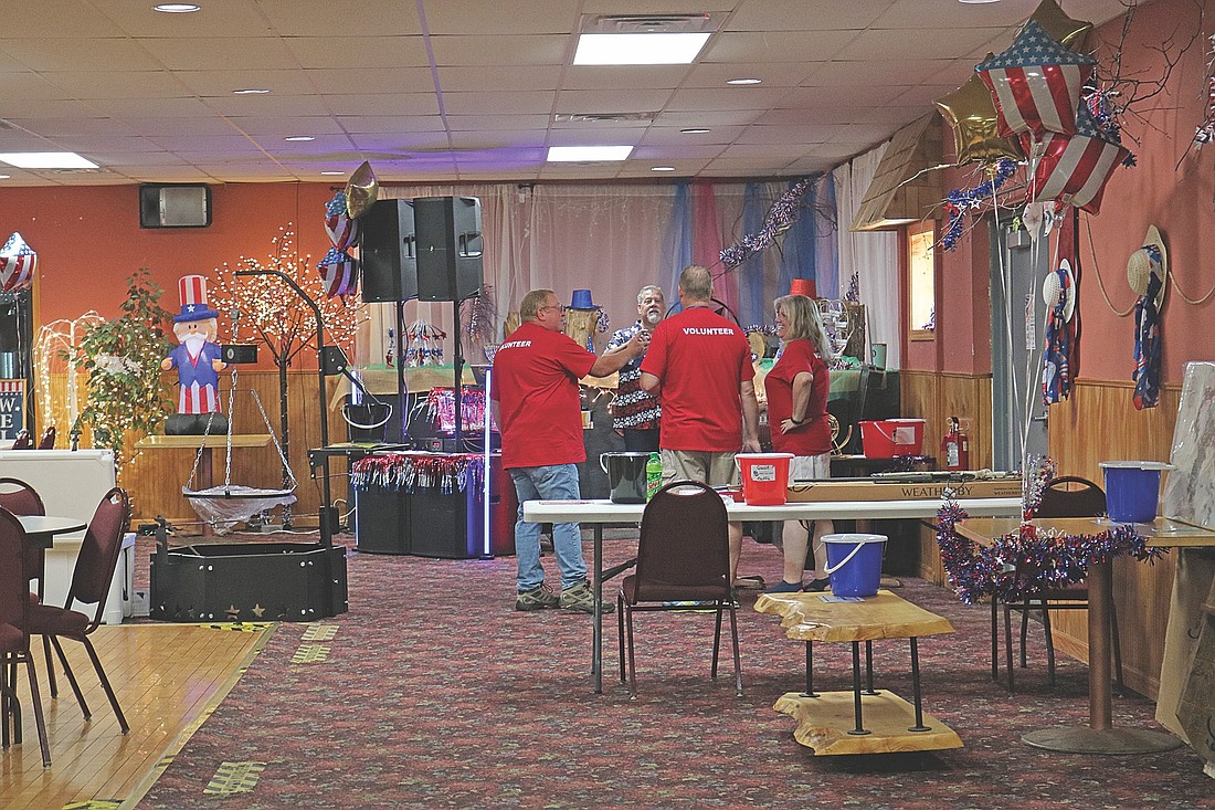 Volunteers spent Saturday morning getting ready for the arrival of guests to the Northwoods Honor Flight benefit. (Photo by Beckie Gaskill/Lakeland Times)