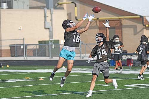 Nolan Johnson leaps for a catch over the outstretched arm of Mitch Mleko during the first day of practice Tuesday, Aug. 5 at IncredibleBank Field in Minocqua. (Photo by Brett LaBore/Lakeland Times)