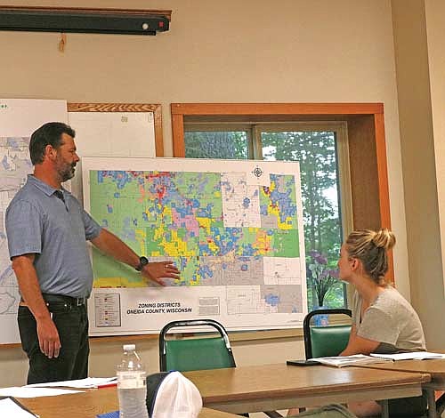Scott Ridderbusch from the Oneida County zoning department spoke with the town of Crescent plan commission, answering questions about zoning designations from committee member Niina Baum and others. (Photo by Beckie Gaskill/Lakeland Times)