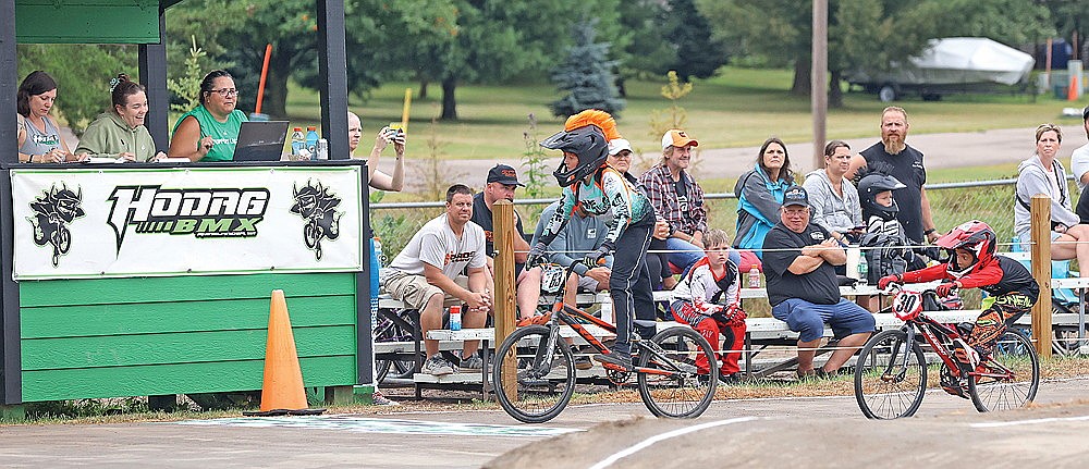 Jackson Stark (63) of Hancock and Jax Johnson (30) of Rhinelander race to a photo finish in the 9 Intermediate class during the Badger State Games races at the Hodag BMX track Saturday, Aug. 9.