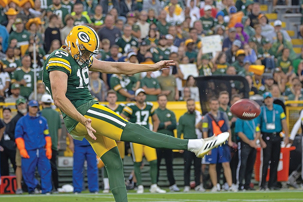 Punter Daniel Whelan boots the ball away during the first quarter of Saturday’s game.