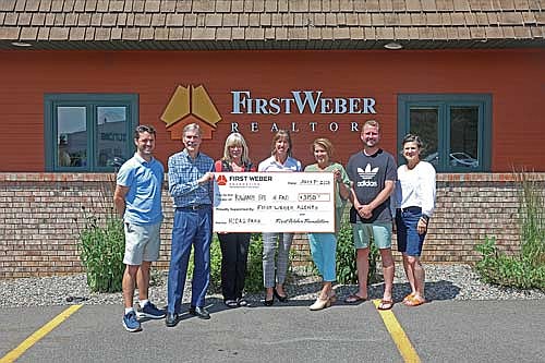 Those pictured for the check presentation, from left, are Ransey Osness of First Weber, Ron Skagen of First Weber and Kiwanis, Linda Moore of First Weber, Stephanie Dahlquist of Kiwanis, Noel Fitzgerald of First Weber, John Zenk of First Weber and Christy Schneider of First Weber. (Contributed photograph)