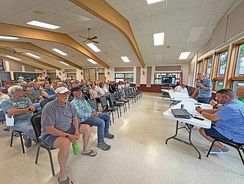 Roughly 50 to 60 people attended a Manitowish Waters special town board meeting on Tuesday about a request by wake surfers to amend ordinances adopted in June to ban boating equipment that produces artificially enhanced wakes on town lakes. (Photo by Trevor Greene/Lakeland Times)