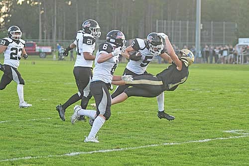 Evan Zoch runs through Hayward’s Charles Egger as Lakeland’s Nathaniel Decora (21) and Michael Schettino (6) look on during a punt-return touchdown in the first quarter of a non-conference game Friday, Aug. 22 at Rod Lundberg Field in Hayward. Zoch scored three touchdowns in the game. (Photo by Brett LaBore/Lakeland Times)