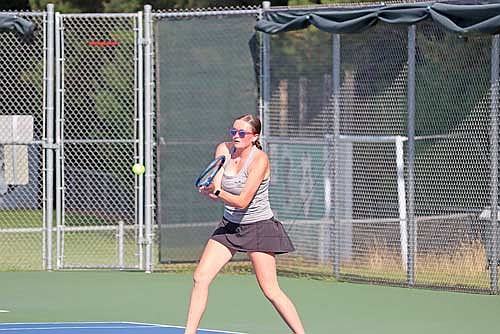 Ellie Glisczinski goes for a groundstroke in her No. 3 doubles match against Wausau Newman in the season opener Thursday, Aug. 21 at the Lakeland Union High School tennis courts in Minocqua. Glisczinski and Carmen Istudor achieved their first win as a pair. (Photo by Kate Reichl/Lakeland Times)