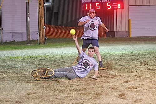 Keagen Leick, WPS Local 420, makes a throw from the ground to get the force out at third base with teammate Ryan Kovak looking on in the fifth inning against the Snowhawks Monday, Aug. 25 at Snowshoe Park in Lake Tomahawk. (Photo by Brett LaBore/Lakeland Times)