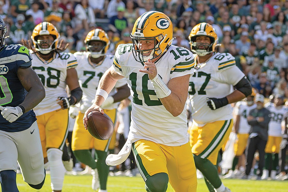 Packers quarterback Sean Clifford scrambles during an NFL preseason game against the Seattle Seahawks at Lambeau Field Saturday, Aug. 23.