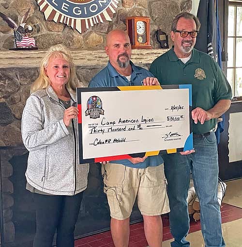 Nancy Woller, Camp American Legion director Jim Klement and Steve Woller at the Aug. 25 check presentation in the main lodge at Camp American Legion in Lake Tomahawk. (Photo by Brian Jopek/Lakeland Times)