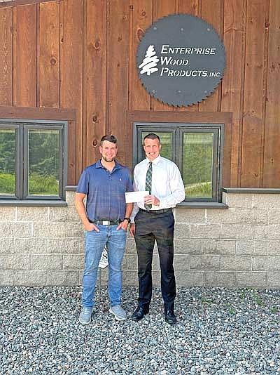 Those present for the check presentation, from left, are owner and president of Enterprise Wood Products Tom Ory and Kiwanis splash pad and project lead Brandon Karaba. (Contributed photograph)