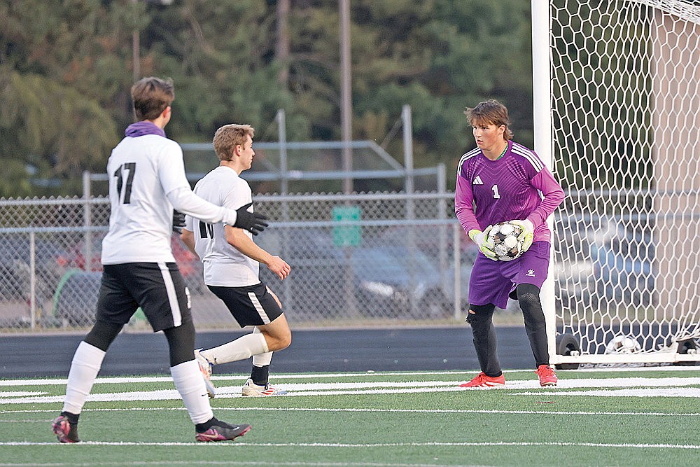 Rhinelander goalkeeper Caden Ehrhardt picks up the ball in front of Mosinee’s Austin Bohman during the first half of a GNC boys’ soccer game at Mike Webster Stadium Monday, Sept. 8. (Bob Mainhardt for the River News)