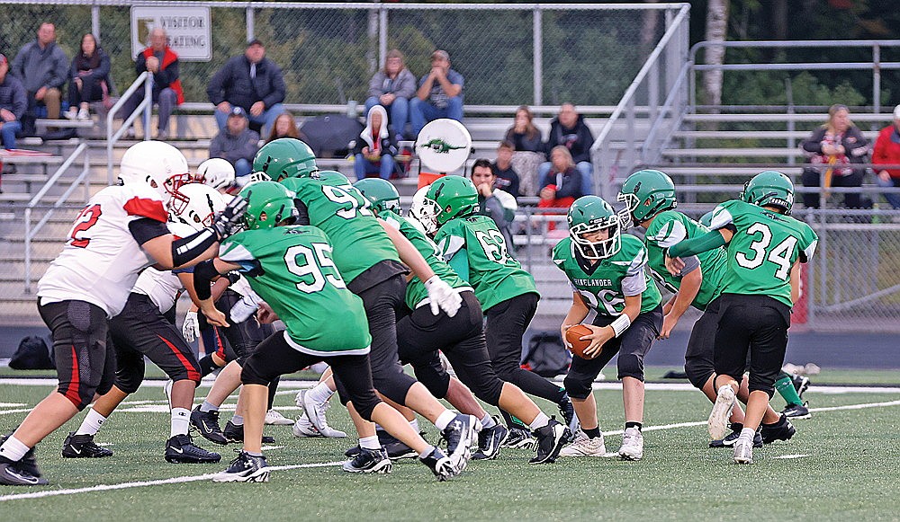 Quarterback Jace Hendrickson takes a snap for the Hodags during the seventh-grade game.