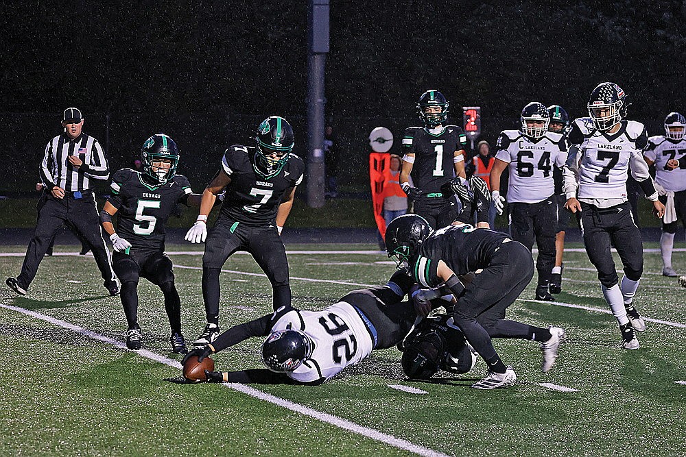 Lakeland’s Justin Doud-Sero reaches for the goal line while being tackled by Rhinelander’s Cyrus Leisure and Ryley Hull (3) during the second quarter of a GNC football game a Mike Webster Stadium Friday, Sept. 5. Lakeland rallied past Rhinelander 43-32 in the 11th playing of the Northwoods Axe Game. (Bob Mainhardt for the River News)
