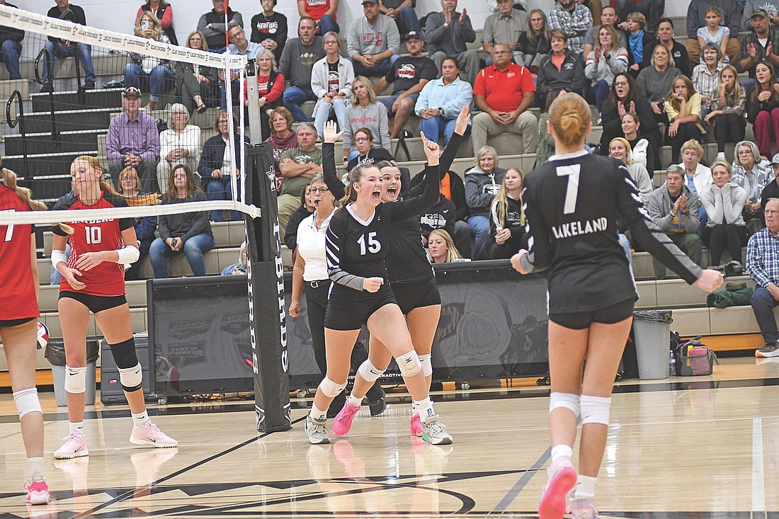 Ava Evenhouse (15) and Marlee Strasburg celebrate a Lakeland point in the first set of a conference match against Medford Tuesday, Sept. 9 at the Lakeland Union High School fieldhouse in Minocqua. The Thunderbirds won the match in three sets. (Photo by Brett LaBore/Lakeland Times)