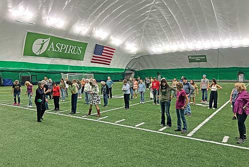 Participants practice a new line dance during the Line Dancing in the Dome event on Thursday, Sept. 11, at the Hodag Dome in Rhinelander. (Photo by Kate Reichl/Lakeland Times)