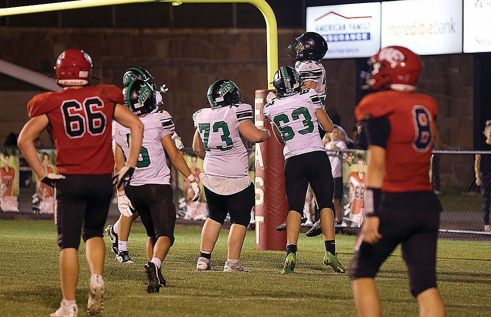 Rhinelander’s Cyrus Leisure (37) celebrates with teammates Leander Sprecksel (63) and Landon Webster (73) after scoring a touchdown in the fourth quarter of a GNC football game against Wausau East in Wausau Friday, Sept. 12. The Hodags scored 28 unanswered points to rally from behind and defeat Wausau East, 28-14. (Bob Mainhardt for the River News)