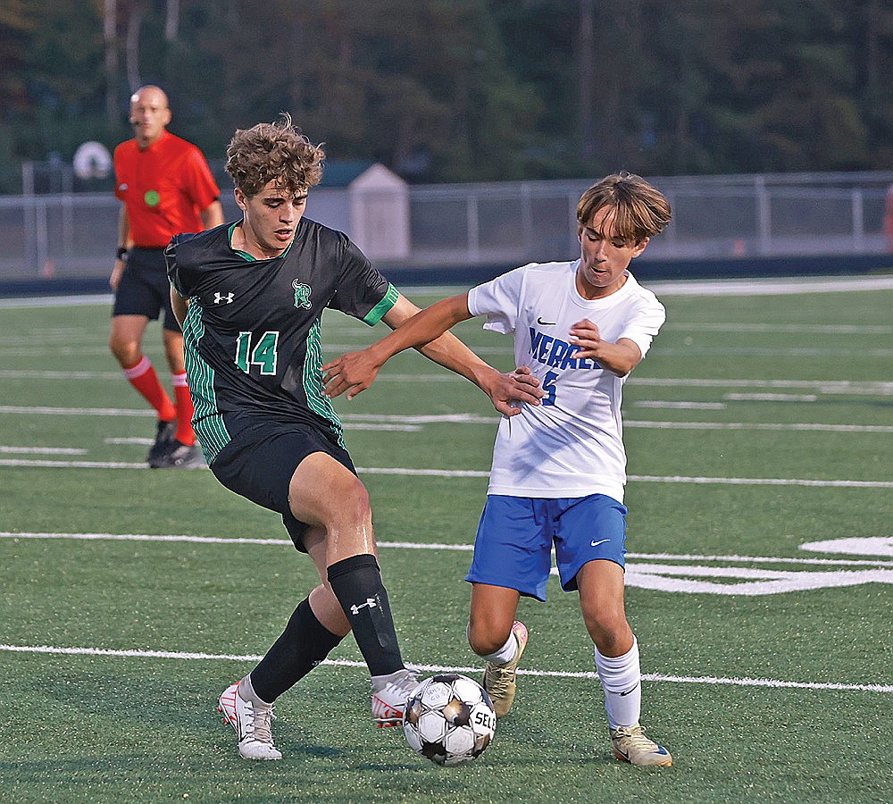 Rhinelander’s Landon Catlin battles Merrill’s Caleb Gennrich for possession during the first half of a GNC boys’ soccer game at Mike Webster Stadium Tuesday, Sept. 16. (Bob Mainhardt for the River News)