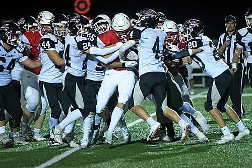 Lakeland players, from left, Hudson Gehl (44), Justin Baird (24), Evan Zoch (5), Tyson Redman (4) and Blake Redman (20) try to bring down Medford’s Carson Ingersoll in the first quarter Thursday, Sept. 18 at Raider Field in Medford. The Raiders rushed for approximately 250 yards. (Photo by Brett LaBore/Lakeland Times)