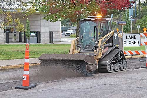 A road construction worker clears off the recently milled surface of Highway 51 near Front street — the southernmost end of the project. (Photo by Michael Strasburg/Lakeland Times)