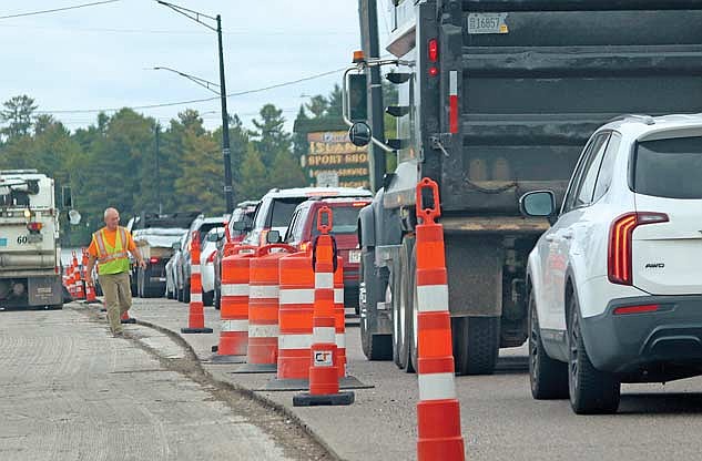 A sweeper truck driver moves cones before making another pass on the recently milled surface of Highway 51 near Torpy Park. (Photo by Michael Strasburg/Lakeland Times)