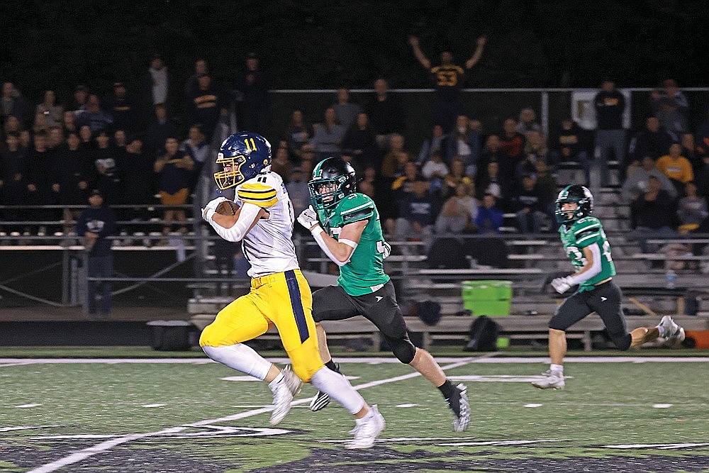 Tomahawk’s Tiegan Sarazin races ahead of Rhinelander’s Cyrus Leisure on a long run during the second quarter of a GNC football game at Mike Webster Stadium Friday, Sept. 19. Tomahawk defeated Rhinelander, 49-7. (Bob Mainhardt for the River News)