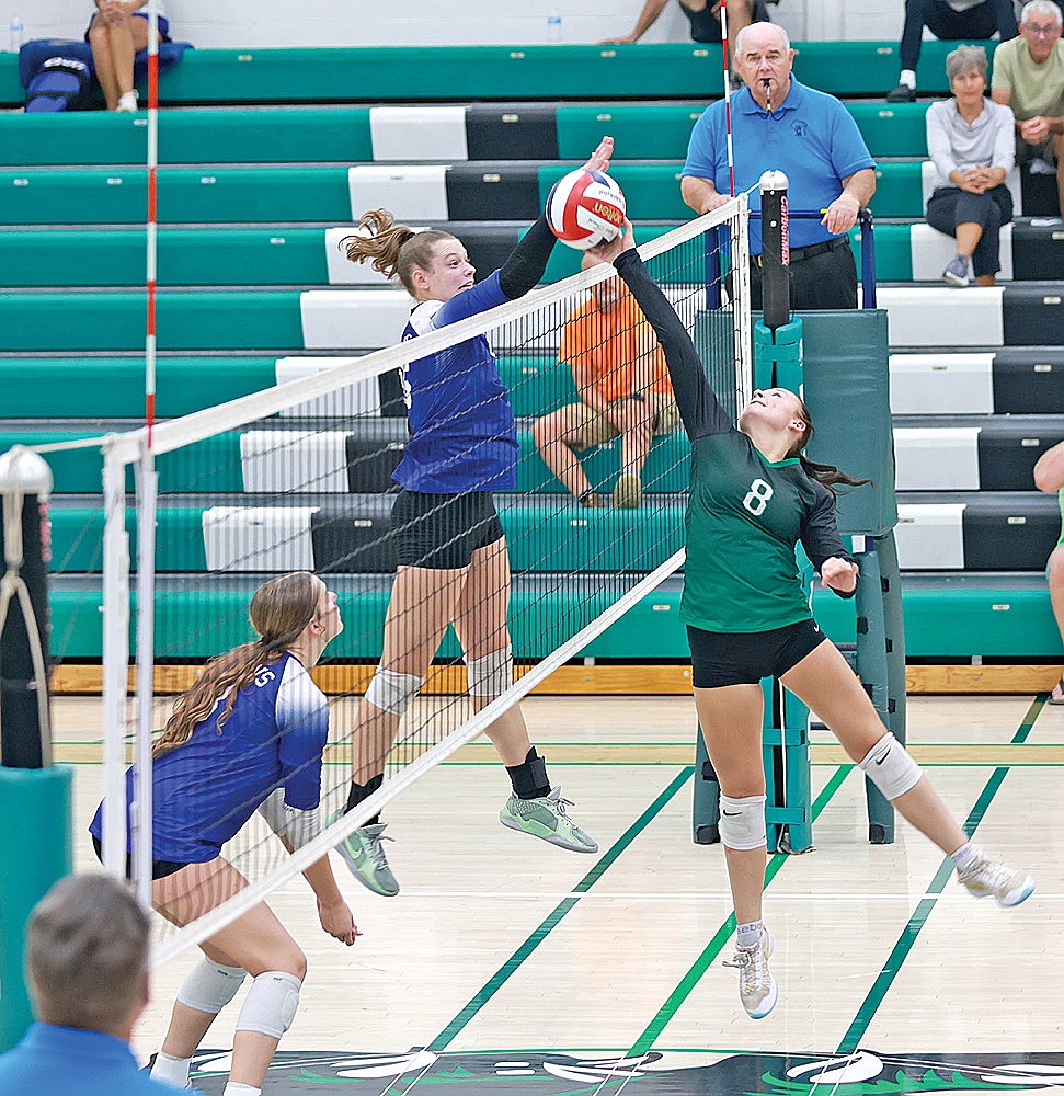 Rhinelander’s Kylie Treder attempts to tip the ball around a block attempt by Amherst’s Alexis Wierzba during a non-conference volleyball match at the Jim Miazga Community Gymnasium Thursday, Sept. 18. (Bob Mainhardt for the River News)