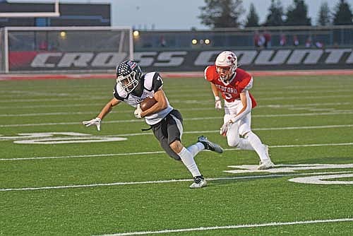 Mitch Mleko makes a catch before heading upfield in the first quarter against Medford Thursday, Sept. 18 at Raider Field in Medford. (Photo by Brett LaBore/Lakeland Times)