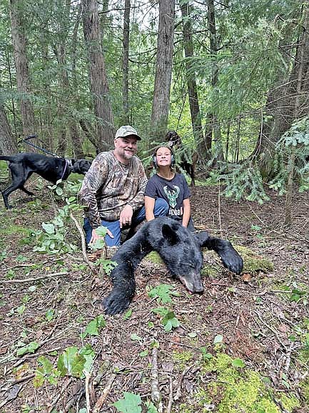 Matt and Sophia Klauck pose for a picture with a bear Sophia was able to harvest this year in Mercer through the United Special Sportsman Alliance organization. (Contributed photograph)