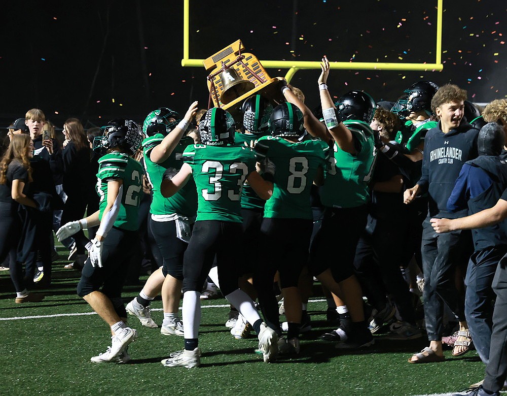 Members of the Rhinelander High School football team celebrate with Gene Shepard's Bell after defeating the Antigo Red Robins 54-8 in the 91st Bell Game at Mike Webster Stadium Friday, Sept. 26. (Bob Mainhardt for the River News)