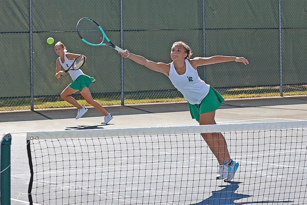 Rhinelander’s Willow Mutter reaches for a ball while teammate Addy Currie looks on during the GNC girls’ tennis tournament at the RHS tennis courts Thursday, Sept. 25. Mutter and Currie were the runners-up at No. 3 doubles and Rhinelander tied for third in the tournament. (Bob Mainhardt for the River News)