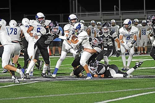 Thunderbird players, from left, Gabe Karch (8), Sean Morgan (25) and Hudson Gehl (44) go to tackle Merrill’s Kanin Jahnke in the second quarter of a conference game Friday, Sept. 26 at IncredibleBank Field in Minocqua. (Photo by Brett LaBore/Lakeland Times)